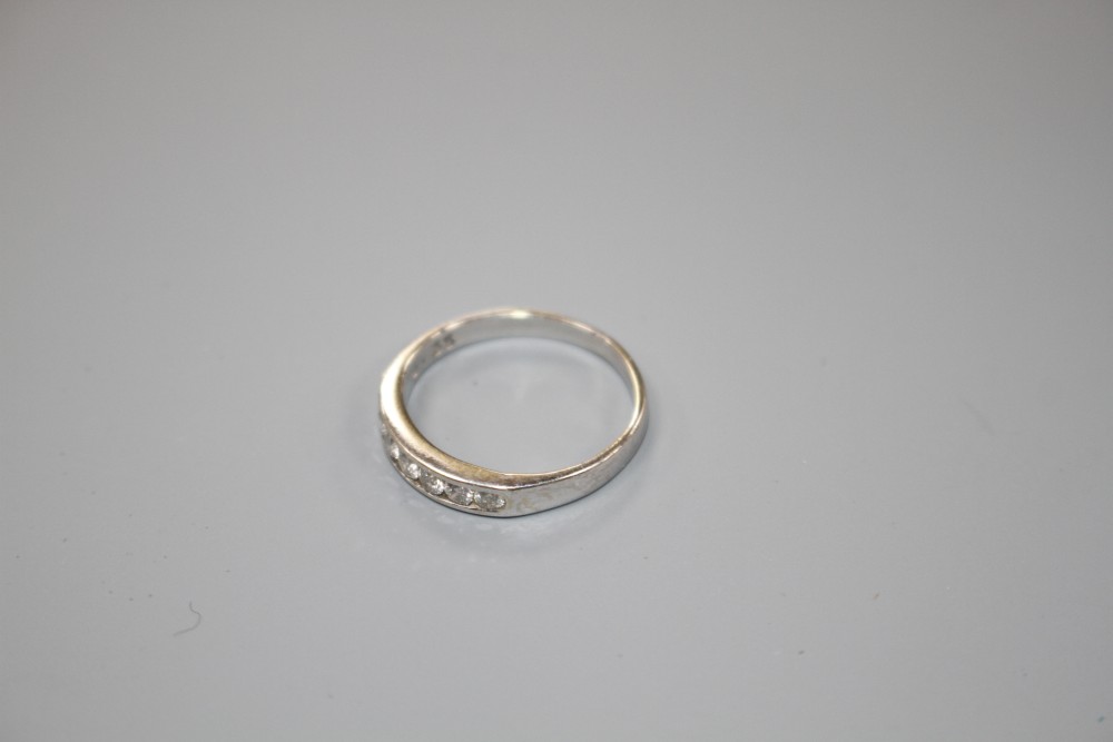 A modern 18ct white gold and seven stone diamond set half eternity ring, size L, gross weight 2.2 grams.